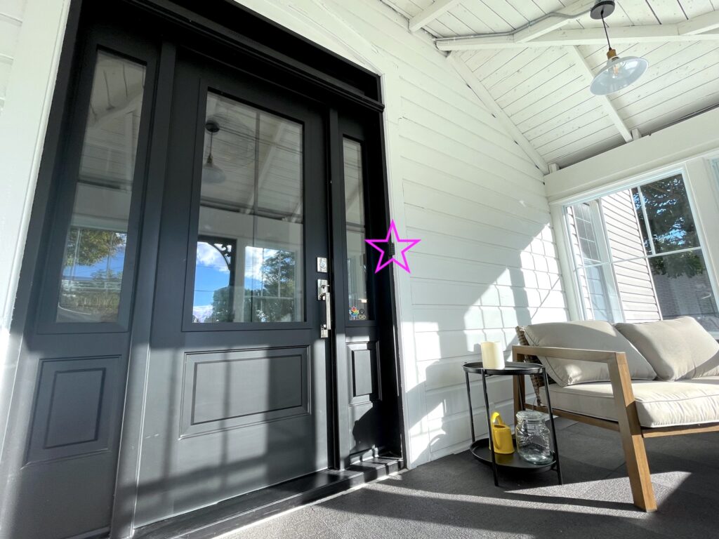 SquirrelHaus PEC's sunporch -- white with a black door and seating