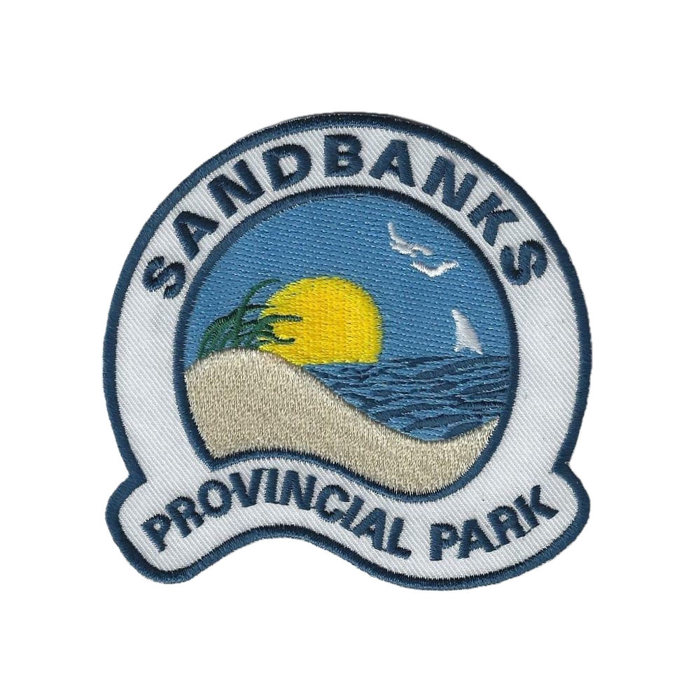Sandbanks Provincial Park badge. A stitched badge with a depiction of a dune, water, sun, and birds.